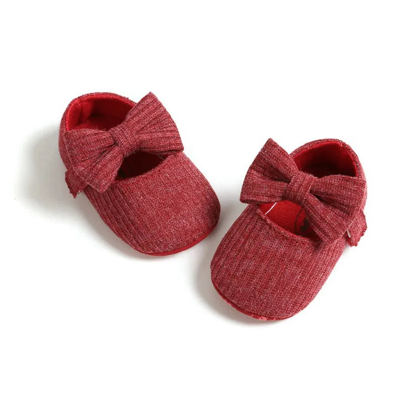 Orange anti-slip baby girl sneakers, soft sole with an adorable contrasting bow.