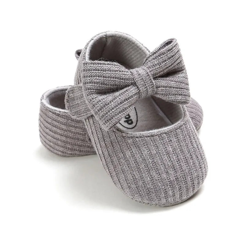 Infant girl's navy anti-slip sneakers featuring a cute bow, flexible soft sole design.