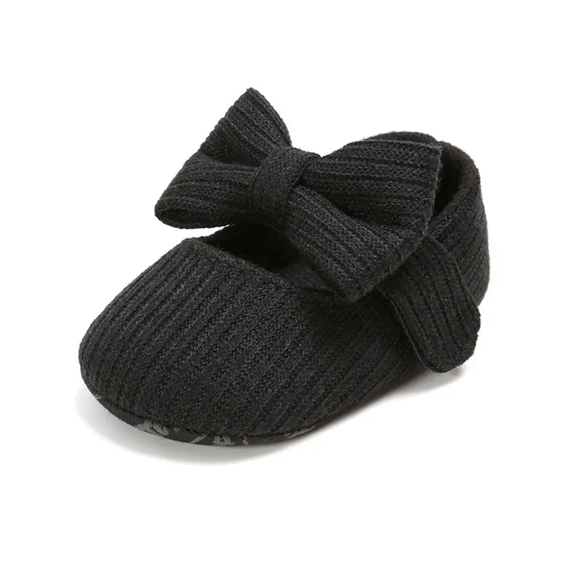Pink soft sole baby sneakers for girls, anti-slip with a charming bow detail on top.