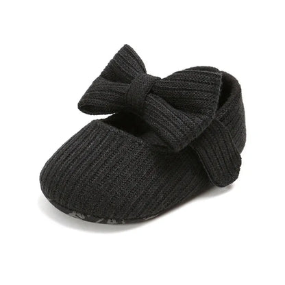 Pink soft sole baby sneakers for girls, anti-slip with a charming bow detail on top.