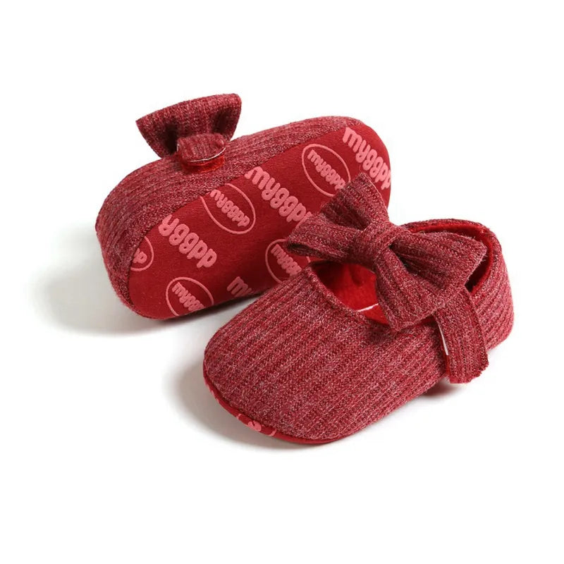 Toddler girl's cream anti-slip bow sneakers, soft sole for comfortable first steps.