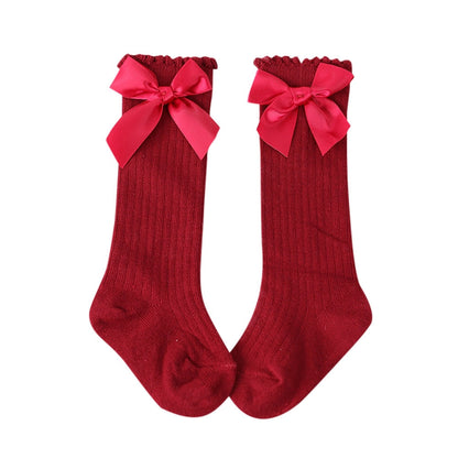 Infant apparel: cozy white cotton knee-high socks for baby girls with bow