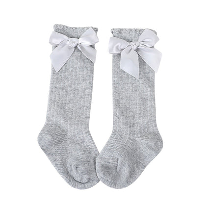 Classic white baby girls' knee-high socks, soft cotton with a sweet bow