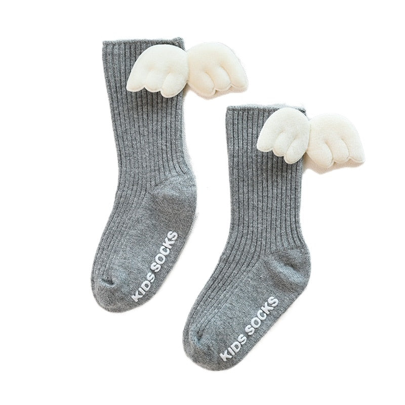 Pink baby girls' knee-high socks, made from premium cotton with bow detail