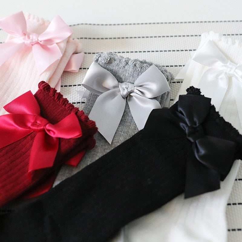 Designed for comfort: baby girls' knee-high cotton socks with bow accent