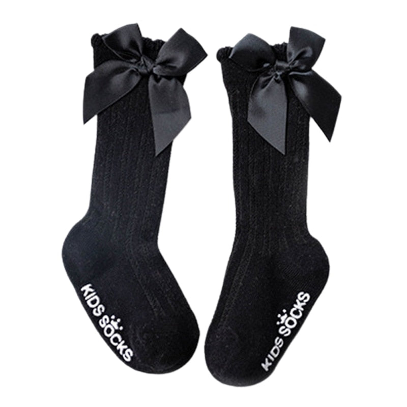Infant girls' comfortable cotton knee-high socks, white with an accent bow