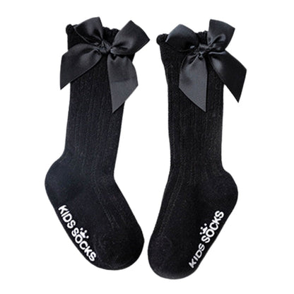 Infant girls' comfortable cotton knee-high socks, white with an accent bow
