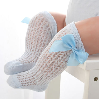 Pair of baby girls' knee-high socks, soft pink cotton with a sweet bowknot