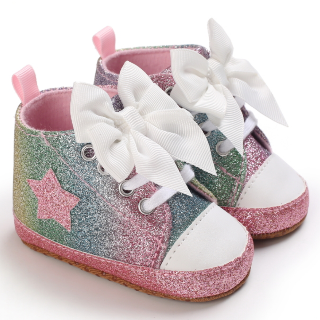 Top-down view of pink hi-top first walker sneakers with bows, ideal baby footwear