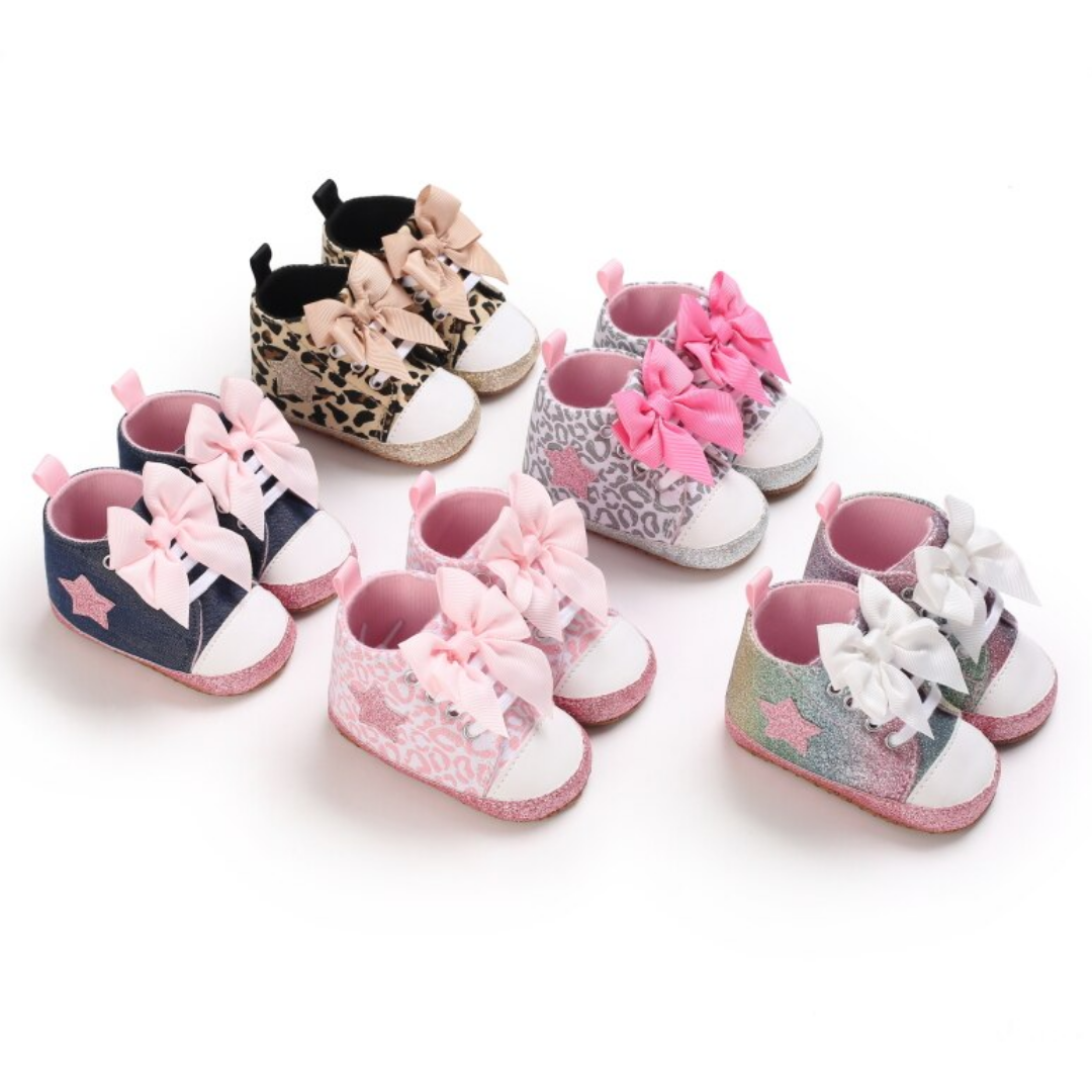 Detail of the soft anti-slip sole on baby girls' hi-top first walker bow sneakers