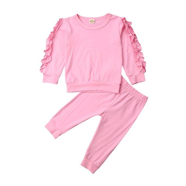 Close-up of soft pink cotton baby sweatshirt with ribbed cuffs, essential girls' clothing