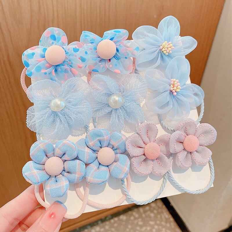 Close-up of a baby girl's elastic hair tie set featuring various pastel colors and patterns