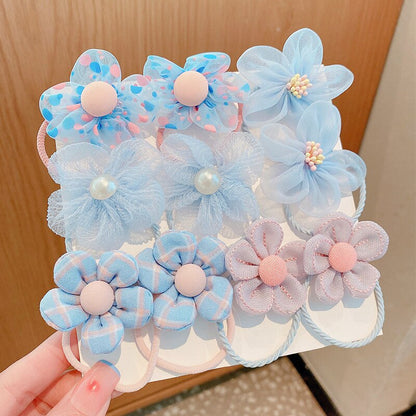Close-up of a baby girl's elastic hair tie set featuring various pastel colors and patterns