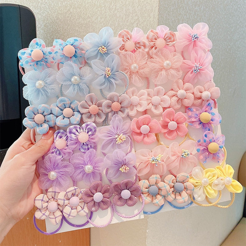 Assorted baby girls' elastic hair ties in a gift box with matching soft headbands