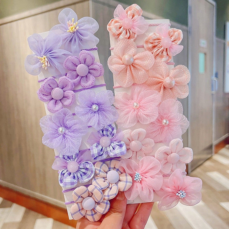 Full range of baby girl's elastic hair ties and headbands, showcasing all available patterns