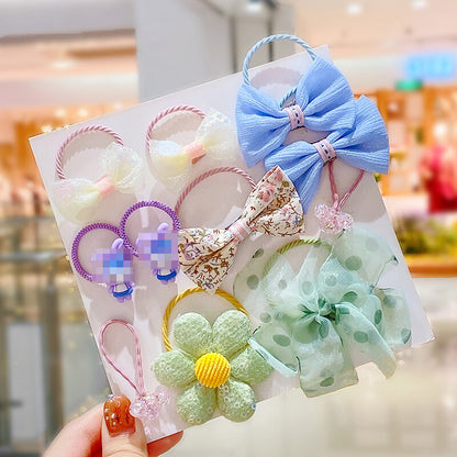 Collection of 10 baby girl's elastic hair ties in pink, white, and floral designs, accessory set