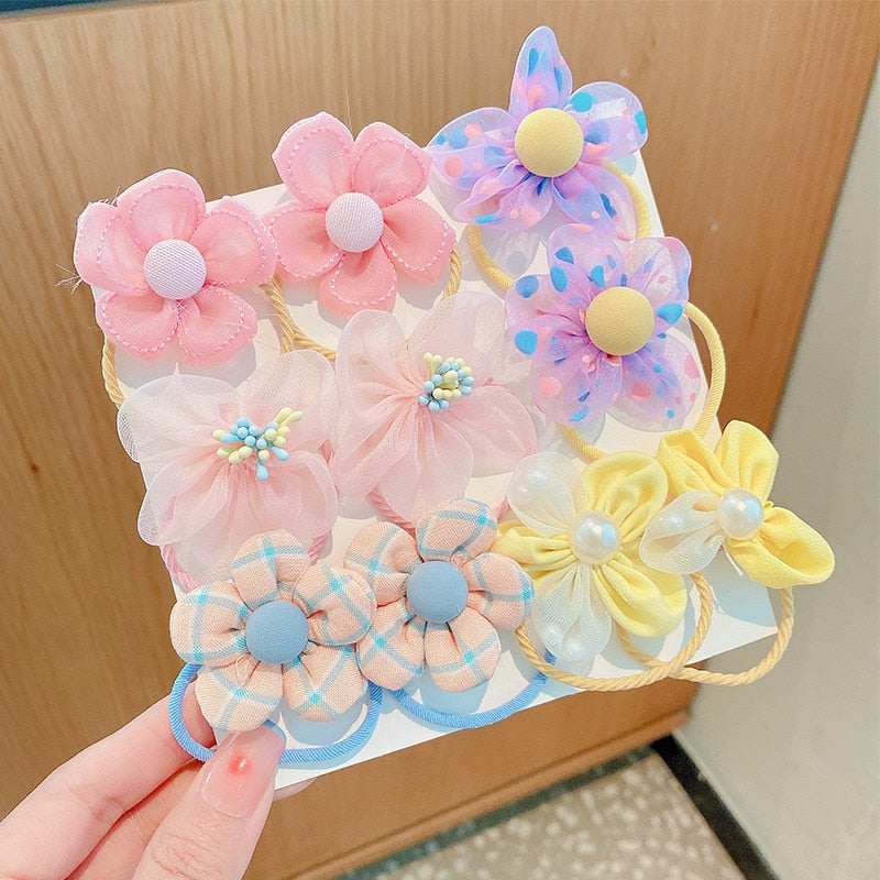 Detailed view of a baby girl's floral print elastic hair tie from the multi-piece set
