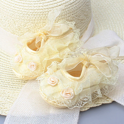 Soft sole baby shoes for girls featuring a beautiful floral lace overlay and satin finish.