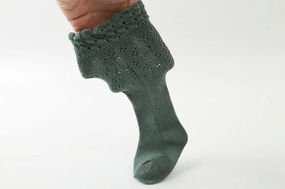 Beige baby girls' cotton blend knee-high socks, hollow knit, offering comfort and style