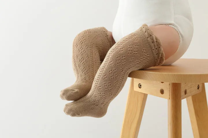Assorted colors of hollow knit knee-high baby girls' socks, breathable and stylish accessories