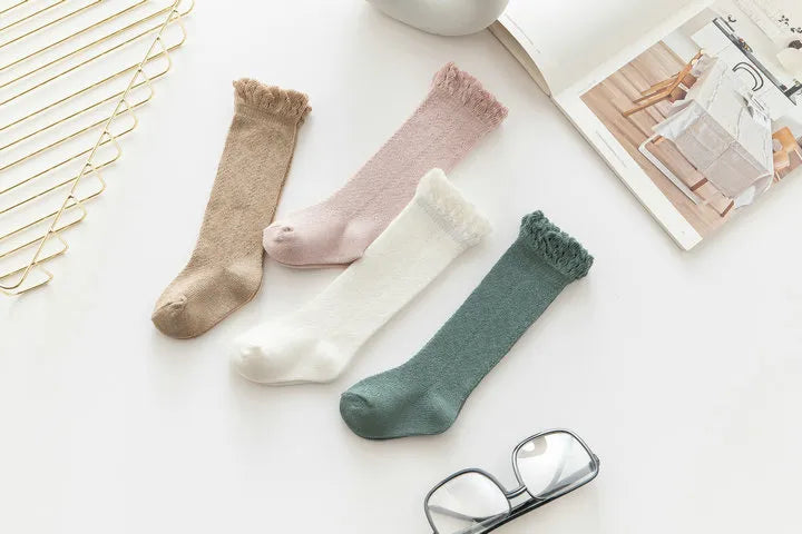 Hollow knit knee-high socks for infant girls, ensuring cool and comfortable feet all day