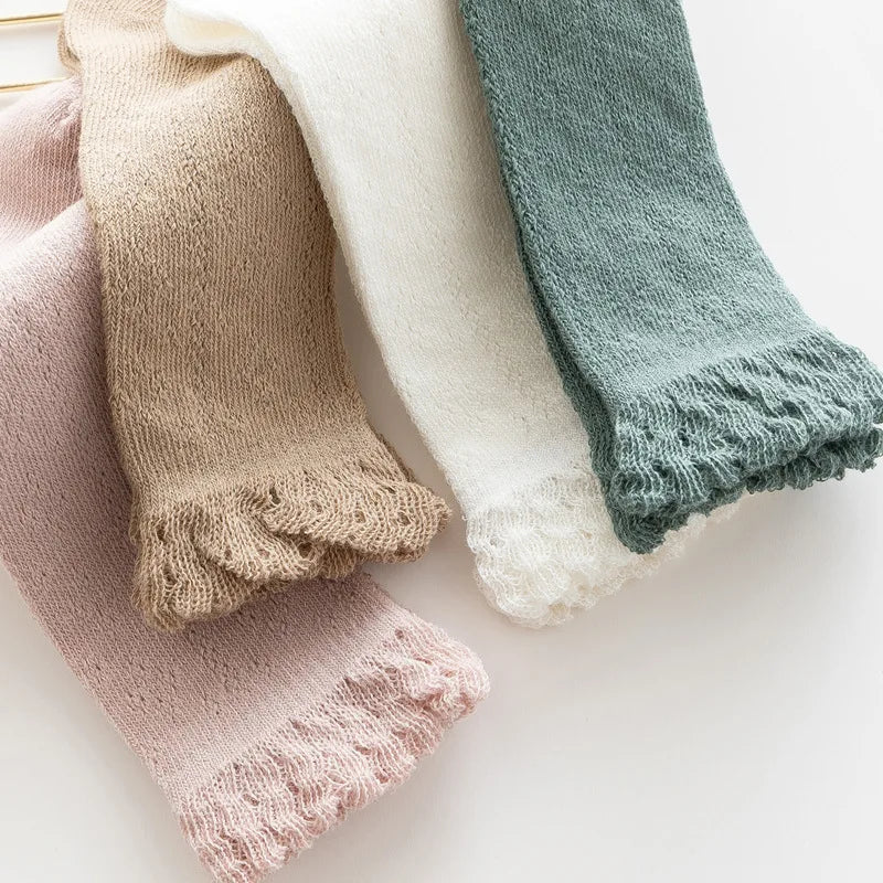 Pack of three baby girls' hollow knit knee-high socks in pastel colors, breathable cotton blend