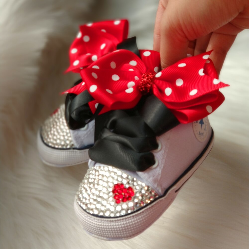 Baby girls' pink polka dot canvas shoes with bowknot closure, perfect for toddler fashion.