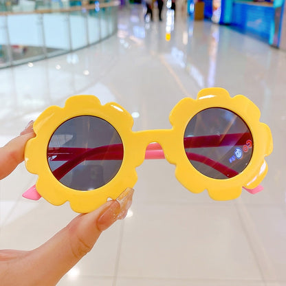 Close-up of pink round baby sunglasses with UV protection for girls 0-6 years