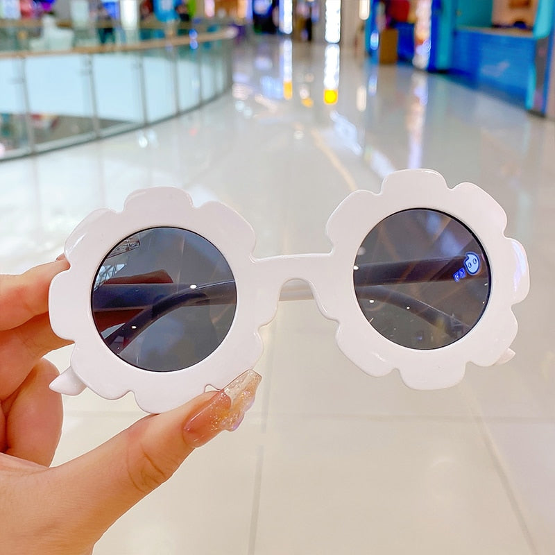 Pink round toddler sunglasses offering full UV protection for outdoor play