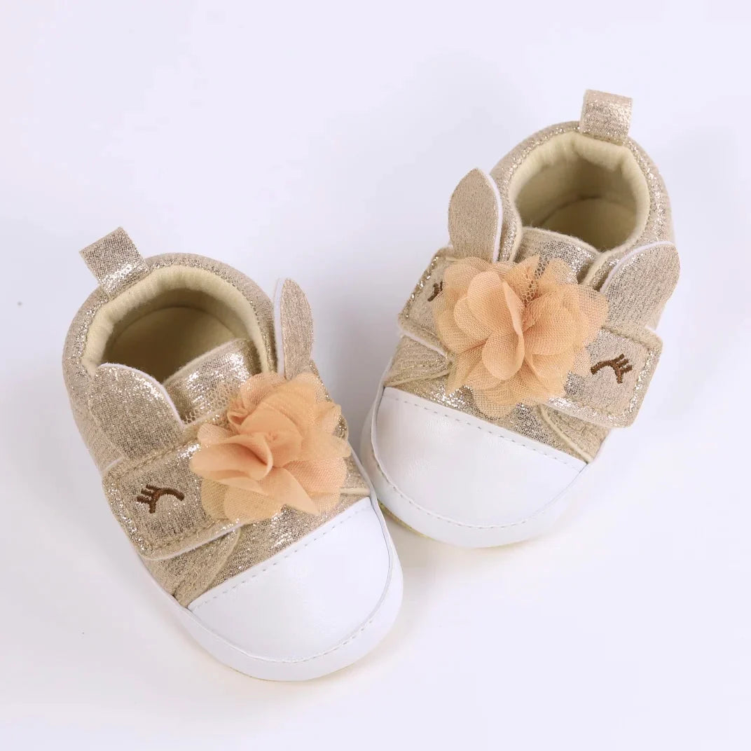 Infant girl's unicorn first walker shoes, providing stability for early steps.