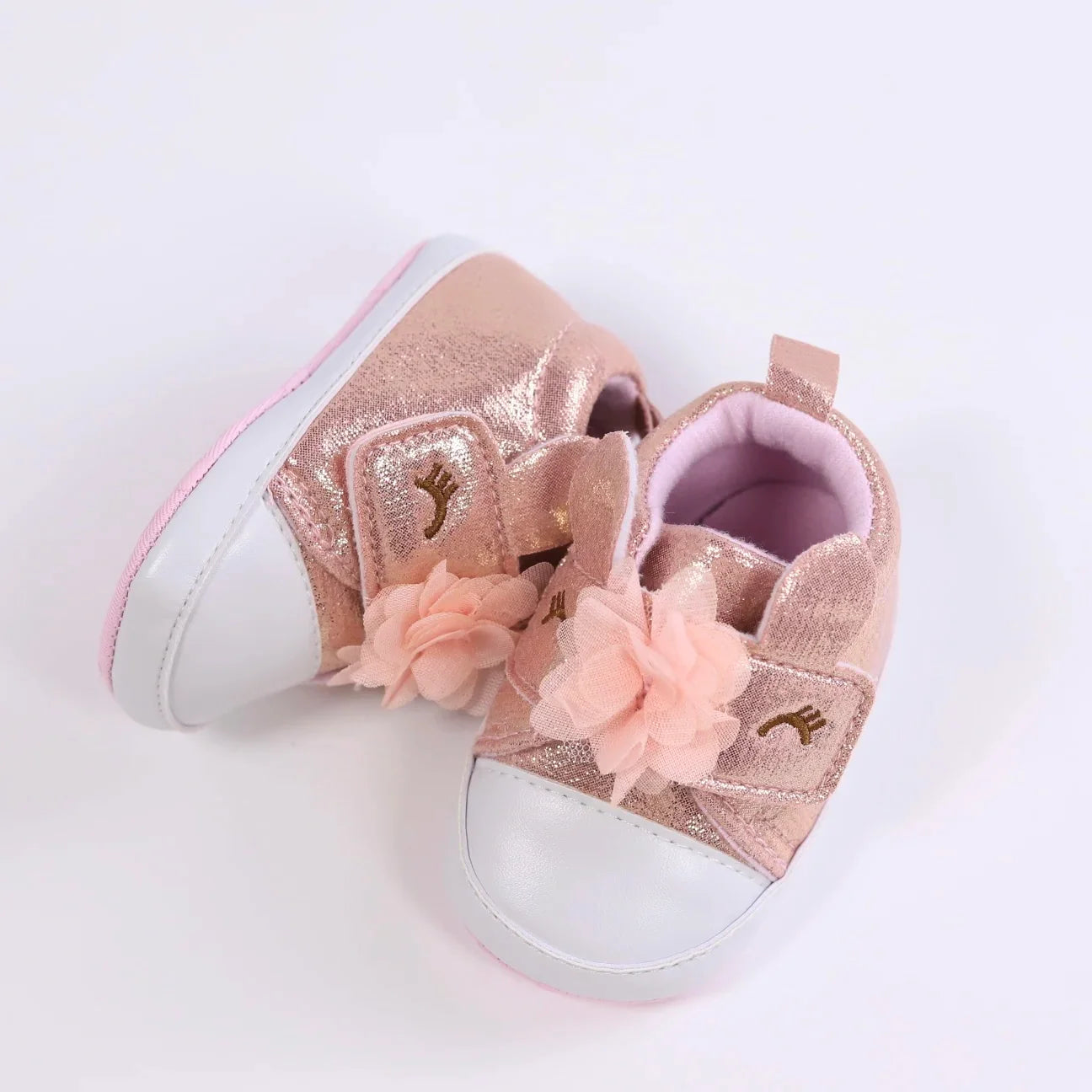 Tiny feet delight: Unicorn themed first walker shoes for baby girls, pink color.