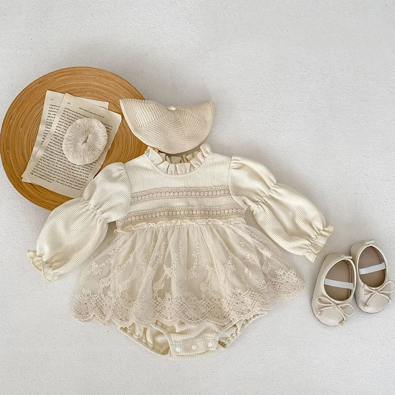 Infant baby girl's fashion: pink waffle knit bodysuit with puff sleeves and sweet lace details.