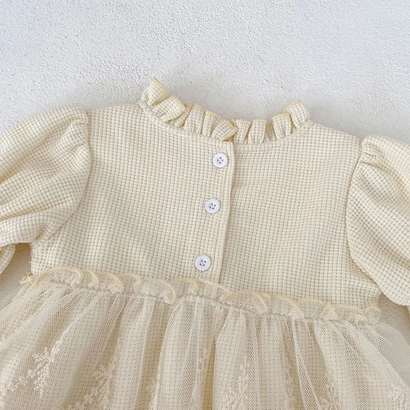 Cute pink waffle knit baby bodysuit for girls, designed with puff sleeves and elegant lace trim.
