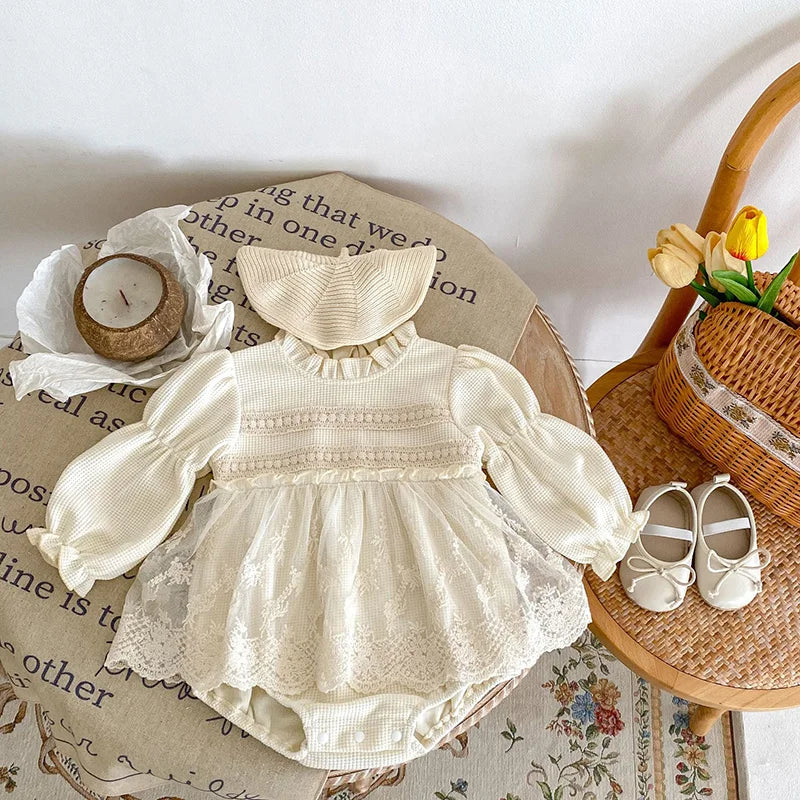 Close-up of baby girl's waffle knit bodysuit in pink, showing puff sleeves and lace detail.