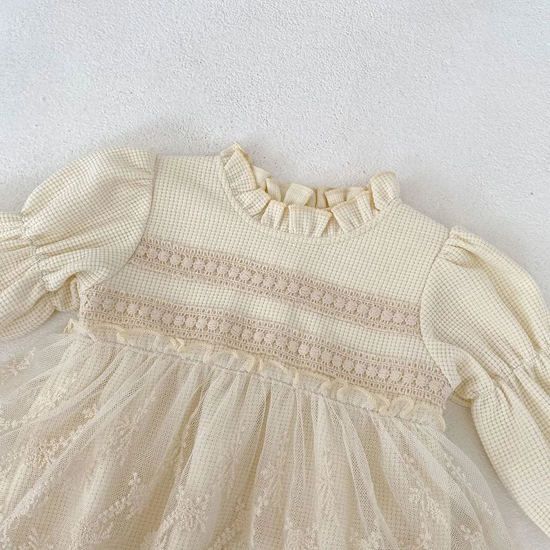 Back view of a comfortable pink waffle knit bodysuit for baby girls, featuring puff sleeves.