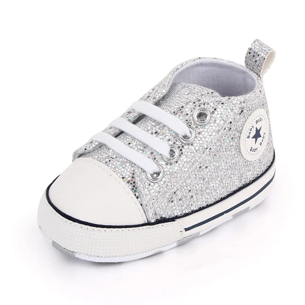 Adorable baby girls' sequined canvas first walking shoes in a vibrant pink color