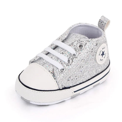 Adorable baby girls' sequined canvas first walking shoes in a vibrant pink color