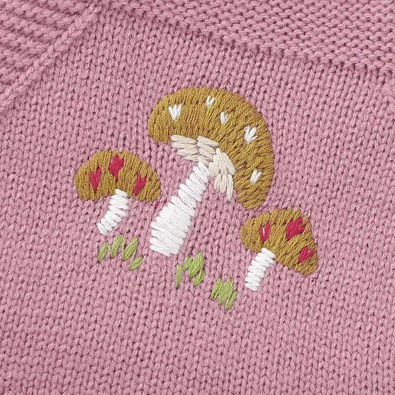 Baby girl in a sleeveless pink knit romper, showing cozy spring baby wear.