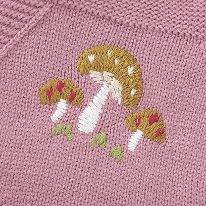 Baby girl in a sleeveless pink knit romper, showing cozy spring baby wear.
