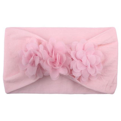 Soft yellow flower elastic headband designed for a baby girl, a comfortable infant accessory.