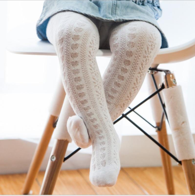 Close-up of soft cotton fabric on baby girls' leggings, highlighting quality and comfort