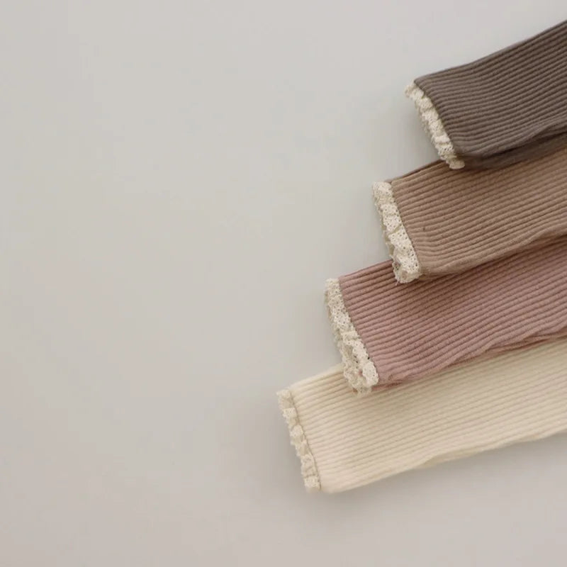 Toddler girl's purple ribbed cotton leggings, an essential for cozy play and easy movement.