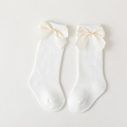 Spanish style baby knee-high socks in cream with elegant matching bows and ruffle