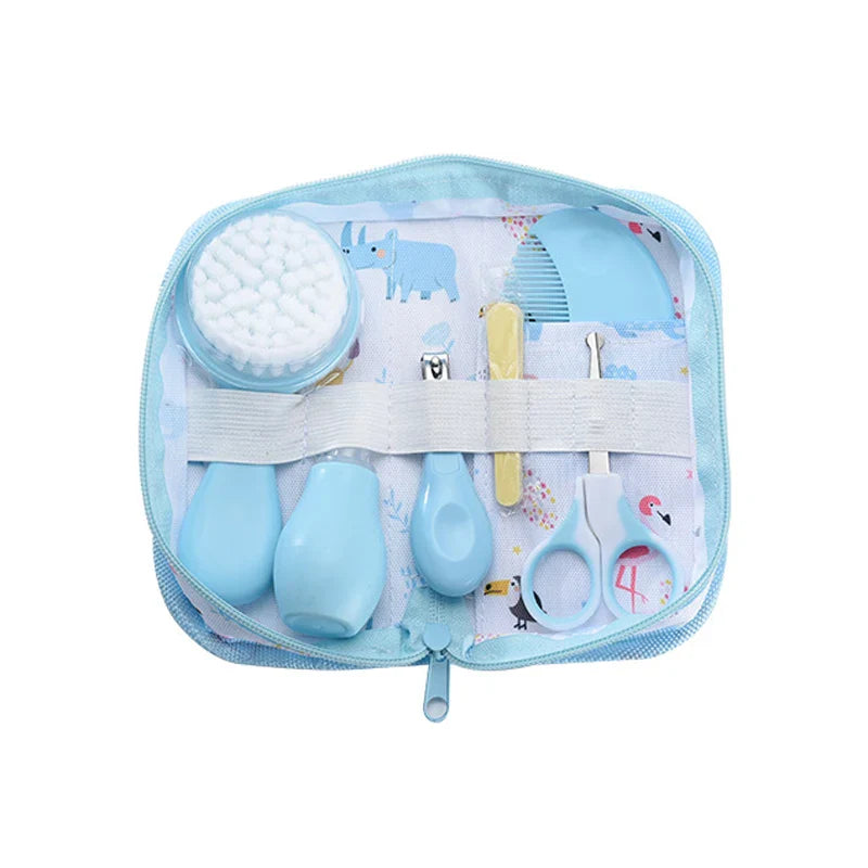 Newborn grooming kit with thermometer, nasal aspirator, and safety nail tools.