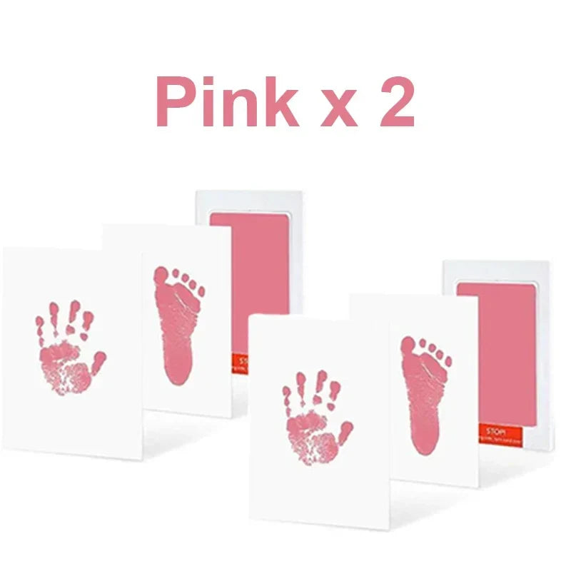 Multiple inkless print cards displaying various baby hand and foot impressions