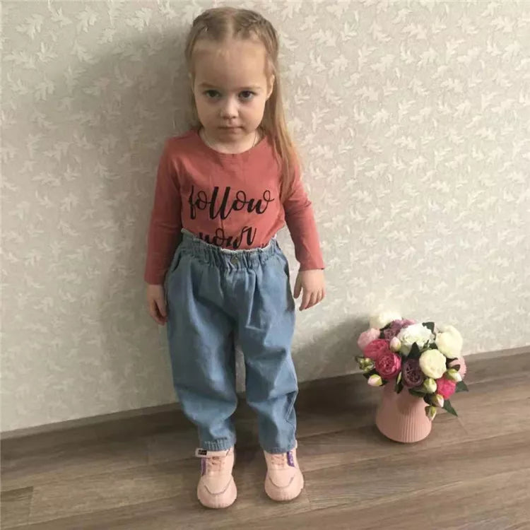 Baby in high-waist denim jeans, casual and comfortable toddler pants, unisex outfit.
