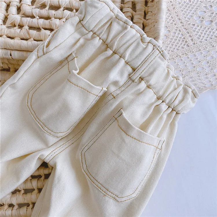 High-waist baby jeans with cuffed hems, trendy unisex toddler denim pants.