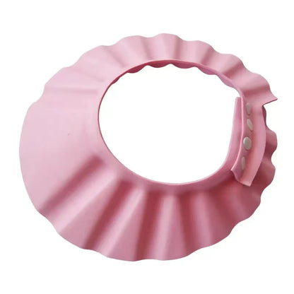 Pink Baby Hippo Shampoo Visor Cap, illustrating its water channeling design for effective shower protection.