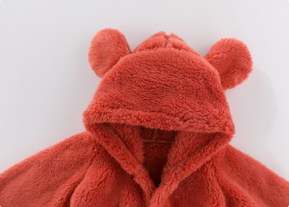 Detailed view of snaps on baby hooded fleece romper for quick and easy diaper access.
