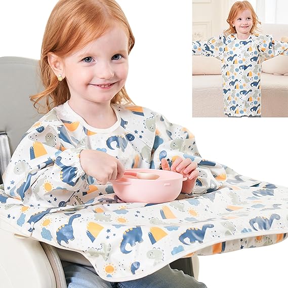 Baby in a pink detachable long-sleeved waterproof bib and smock, eating pureed food mess-free.